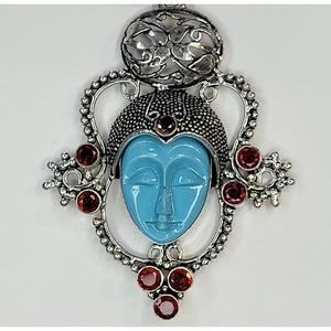 Sterling Silver Pendant with Blue Carved Face and Garnet Accents